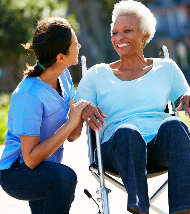 senior woman on a wheelchair together with her caregiver