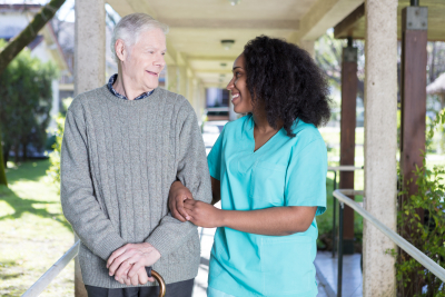 caregiver and senio man talking outdoor